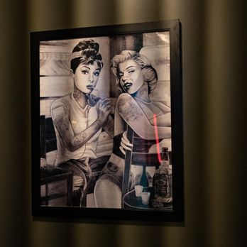 Western Barcode - a woman and a man sitting at a table - Poutineries Near Me - Edmonton, Alberta