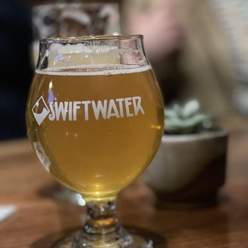 Swiftwater Brewery - a glass of beer on a table - New American Near Me - Rochester, New York