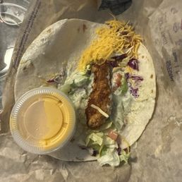 Crispy chicken taco with a tender smaller than my pinky. Added cheese cup for comparison Crispy chicken taco with a tender smaller than my pinky. Added cheese cup for comparison