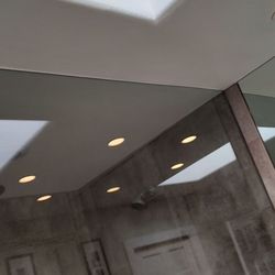 Luxury Home Remodeling - Completed repairs from water damaged ceiling. Drywall tape and smooth texture, plus paint.