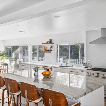 Excel Design and Build - Custom kitchen remodel featuring a stunning quartz island, custom cabinetry, and an open-concept layout in Mission Viejo. - General Contractors Near Me
