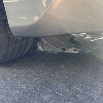Worldwide Bumper Repair - Car is undriveable because of this guys negligence. This wheel well is not completely worn off and scrapes along the road. - Body Shops Near Me