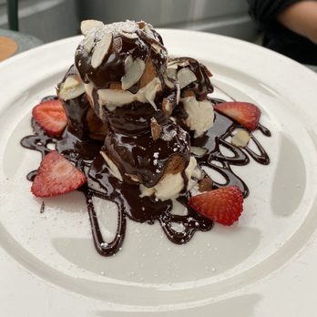 Maximilien - Profiteroles au chocolat- Olympic Mountain Vanilla Ice Cream-filled cream puffs, topped with chocolate sauce - French Near Me - Seattle, Washington Maximilien - Profiteroles au chocolat- Olympic Mountain Vanilla Ice Cream-filled cream puffs, topped with chocolate sauce - French Near Me - Seattle, Washington