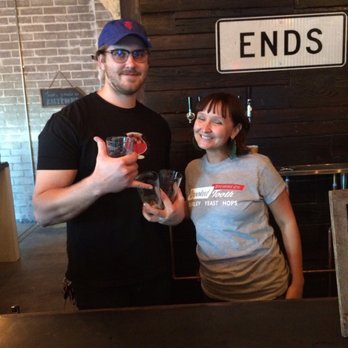Crooked Tooth Brewing - One of the owners, Julie Vernon, with one of the brewers, Tyler. - Breweries Near Me - Tucson, Arizona Crooked Tooth Brewing - One of the owners, Julie Vernon, with one of the brewers, Tyler. - Breweries Near Me - Tucson, Arizona