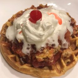 Cake Waffle with fruit toppings, nuts and whipped cream.