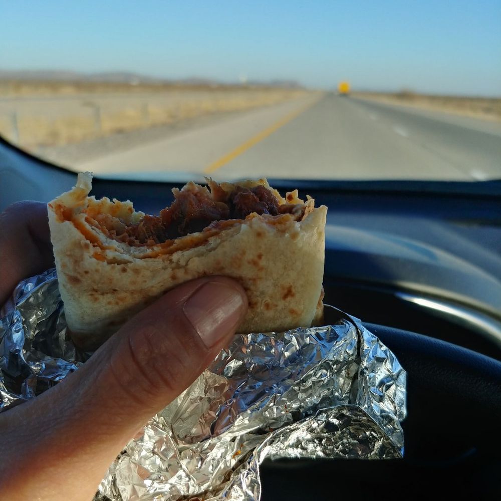 a hand holding a burrito a hand holding a burrito