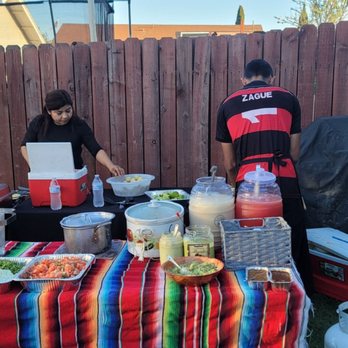 Saya Tacos - two people preparing food on a table - Tacos Near Me Saya Tacos - two people preparing food on a table - Tacos Near Me