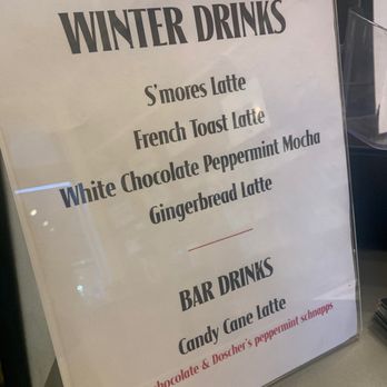 Sidewinder Coffee - Winter 2021 - A menu board displays winter drinks like S'mores Latte and Gingerbread Latte, and bar drinks including Candy Cane Latte, with a note about white chocolate and peppermint schnapps. - Coffee & Tea Near Me - Cincinnati, Ohio