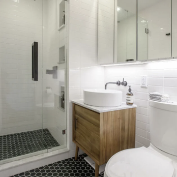 TimberTail Construction - a bathroom with a toilet, sink, and shower - General Contractors Near Me TimberTail Construction - a bathroom with a toilet, sink, and shower - General Contractors Near Me