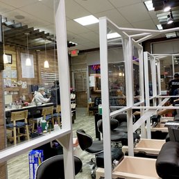 Partitioned pedicure stations. Really neat how they created individual rooms out of plexi to keep customers and employees safe.