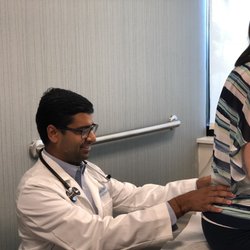 Interventional Pain & Wellness Center - Dr. Tripathi examining a patient