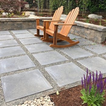 Leafy Landscape - Stone sweating wall, concrete stepping stones, mulch and pea gravel, designed to conserve water. - Landscaping Near Me Leafy Landscape - Stone sweating wall, concrete stepping stones, mulch and pea gravel, designed to conserve water. - Landscaping Near Me