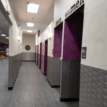 Planet Fitness - The hallway consisting of rooms with tanning and red light beds. - Trainers Near Me - Melbourne, Florida