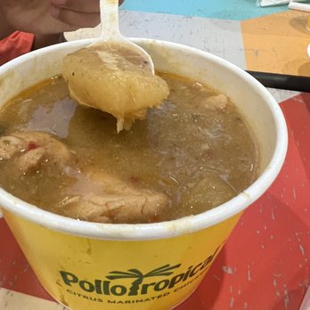 Pollo Tropical - a bowl of soup with a spoon in it - Latin American Near Me - Sunny Isles Beach, Florida