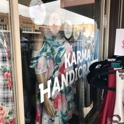 Sign on window was covered by rack of clothes outside
