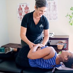 Golden Chiropractic - Dr. Goldi Jacques-Maynes preparing to perform a low back adjustment.