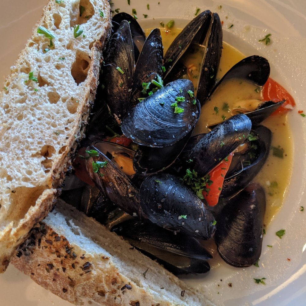 Ports Cafe - Mussels in white wine sauce with house focaccia - New American Near Me - Geneva, New York Ports Cafe - Mussels in white wine sauce with house focaccia - New American Near Me - Geneva, New York