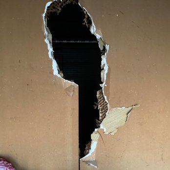 Porterville Storage - Hole from where they broke through and went into other units - Self Storage Near Me - Porterville, California