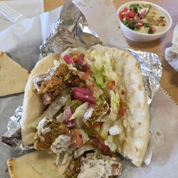 Pita Corner- Peachtree Corners - Partially eaten falafel pita They put tahini dressing on it fir me instead of tzaki, since I am vegan - Greek Near Me - Peachtree Corners, Georgia Pita Corner- Peachtree Corners - Partially eaten falafel pita They put tahini dressing on it fir me instead of tzaki, since I am vegan - Greek Near Me - Peachtree Corners, Georgia