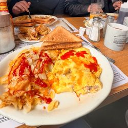 Meadowbrook Diner - Cheesesteak Omelette, Crispy Home-fries, and Wheat Toast.