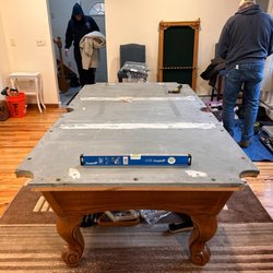 Action Billiards Services - Slate table on a floor that isn't perfectly level (almost all floors). They took time to shim it and make sure the table was level.