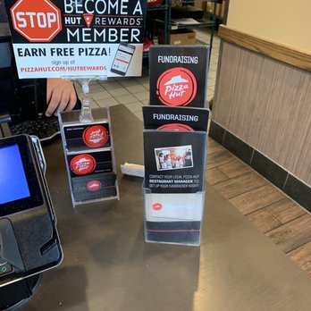 Pizza Hut - a person standing at a counter with a laptop - Pizza Near Me - Alabaster, Alabama