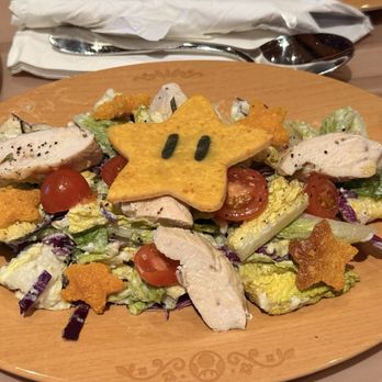 Toadstool Cafe - Super Star Chicken Salad | Romaine and cabbage mix, tomatoes, and mushrooms tossed in creamy mushroom truffle dressing with grilled chicken - Burgers Near Me - Orlando, Florida