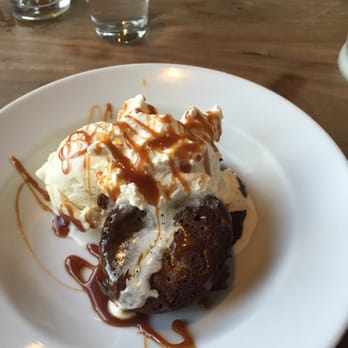 Catelli's - Chocolate molten lava cake is served with whip cream, ice cream and salted caramel sauce. - New American Near Me - Geyserville, California
