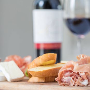 Garden Bistro & Bar - a wooden cutting board with cheese, meat, bread, and a glass of red wine - Cafes Near Me - Orlando, Florida Garden Bistro & Bar - a wooden cutting board with cheese, meat, bread, and a glass of red wine - Cafes Near Me - Orlando, Florida