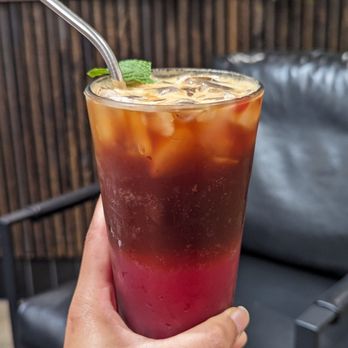 Tala Coffee Roasters - a hand holding a tall glass of iced tea - Coffee Roasteries Near Me - Libertyville, Illinois