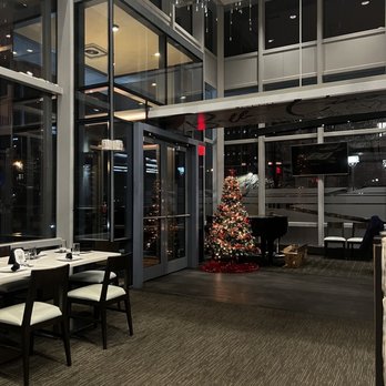 Bella Ciao - a dining room with a christmas tree in the background - Italian Near Me - Buffalo, New York