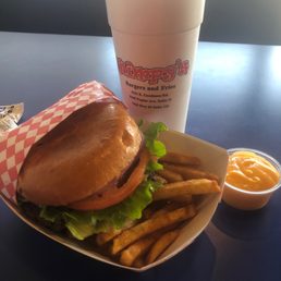 Wimpy burger with fries and cheese sauce on the side. Wimpy burger with fries and cheese sauce on the side.