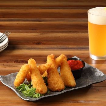 Hickory Tavern - a plate of deep fried fish sticks and a glass of beer - American Near Me - Cary, North Carolina