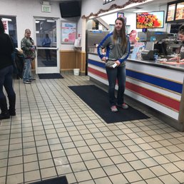 a woman standing in front of a counter