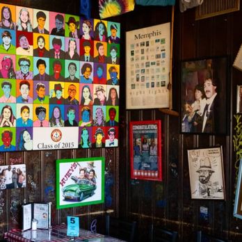 Huey's Midtown - A corner table at Huey's, surrounded by walls covered in photos, news articles, and other items honoring the city of Memphis - Burgers Near Me - Memphis, Tennessee Huey's Midtown - A corner table at Huey's, surrounded by walls covered in photos, news articles, and other items honoring the city of Memphis - Burgers Near Me - Memphis, Tennessee