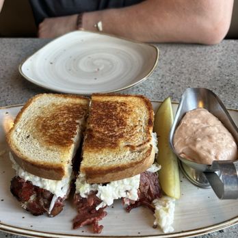 Noni's Grille - Noni's special. Corned beef and pastrami with coleslaw. The sandwich was huge, big enough for 2 people. It was delicious! - American Near Me - Troy, Michigan