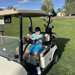 Liam using a golf cart in the South Par three.