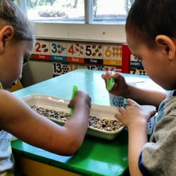 Pennington Children's Academy - Math activity. Kiddies are given a cup with a number on it like #6. They then pick up 6 corn kernels and put them into the cup.