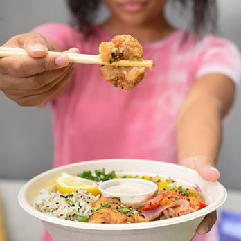 Moonbowls - a woman holding a bowl of food - Korean Near Me - Columbus, Ohio Moonbowls - a woman holding a bowl of food - Korean Near Me - Columbus, Ohio
