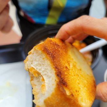 Magic Fusion Cuisine - a person eating a sandwich - Fast Food Near Me - Markham, Ontario