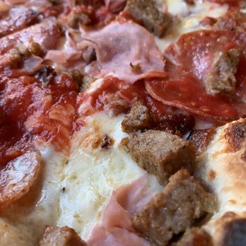 Pizza Domenica - Tutto carne (fennel sausage, ham, salami, bacon) close-up - Pizza Near Me - New Orleans, Louisiana Pizza Domenica - Tutto carne (fennel sausage, ham, salami, bacon) close-up - Pizza Near Me - New Orleans, Louisiana