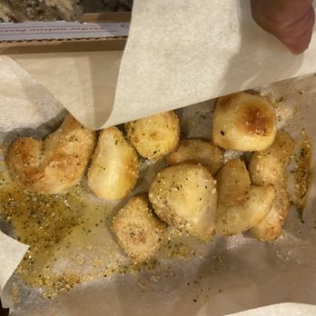 Domino's Pizza - a person holding a piece of paper with some food on it - Pizza Near Me - Wake Forest, North Carolina