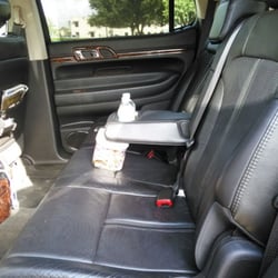 Nicon Towncar & Limousine Services - Black luxurious interior with complimentary phone charger and bottle water standard.