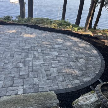 Northeast Landscape & Irrigation - a view of a patio with a lake in the background - Landscaping Near Me - Standish, Maine Northeast Landscape & Irrigation - a view of a patio with a lake in the background - Landscaping Near Me - Standish, Maine