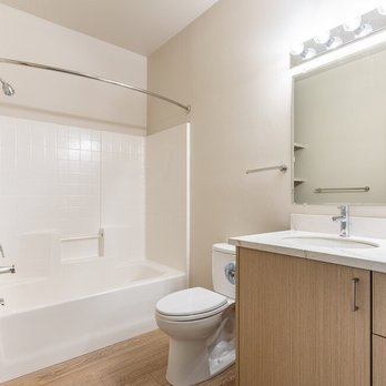 Wilsonville Summit Apartments - A white bathroom with a toilet, sink, and bathtub - Apartments Near Me - Wilsonville, Oregon Wilsonville Summit Apartments - A white bathroom with a toilet, sink, and bathtub - Apartments Near Me - Wilsonville, Oregon