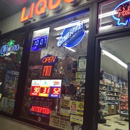 a liquor store with neon signs a liquor store with neon signs
