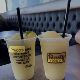 two drinks with straws on a table two drinks with straws on a table
