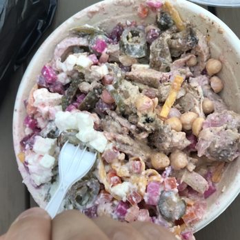 Shell - A large bowl contains a mixed salad with vegetables, chickpeas, and creamy dressing, with a plastic fork inserted. - Gas Stations Near Me - Royal Oak, Michigan