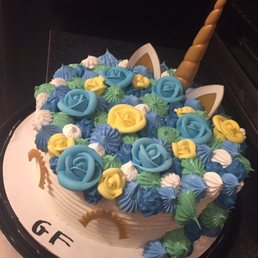 a cake decorated with blue and yellow flowers