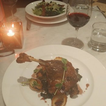 Biff's Bistro - Duck confit. With ceasar salad in the background. Definitely a successful dish! - French Near Me - Toronto, Ontario
